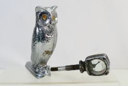A vintage car mascot in the form of a standing owl,