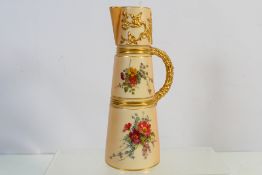 An early 20th century Royal Worcester blush ivory claret jug decorated with floral sprays and with