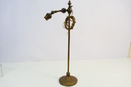 An antique Faraday & Son brass table lamp (lacking shade),