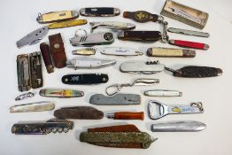 Knives - 30 pocket knives of various sizes, styles, and grips.
