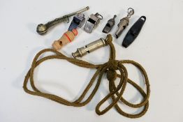 Various whistles - one police type marked 1915, two referee, three toy whistles, and a boson's pipe.