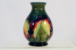 Moorcroft - A Walter Moorcroft vase of ovoid form, decorated in the Leaf And Berries pattern,