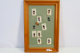 A framed display of eleven Robertson's enamel advertising badges,