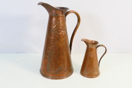 Joseph Sankey & Sons - A set of two Art Nouveau copper jugs of tapered form jugs embossed with
