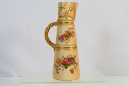 An early 20th century Royal Worcester blush ivory claret jug decorated with floral sprays and with