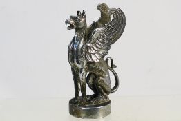 A vintage car mascot in the form of a seated griffin, approximately 13 cm (h).