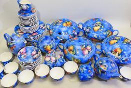 A quantity of fruit decorated dinner and tea wares, marked to the bases Rococo, Ravenscroft,