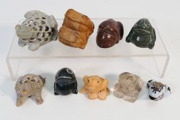 A collection of small frog figures, carv