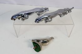 Three chrome car mascots comprising two