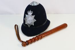 A police / custodian helmet with Cheshire Constabulary plate and a turned wooden truncheon,