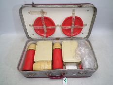 A vintage cased picnic set.