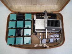 A vintage Gnome slide projector, contained in case.
