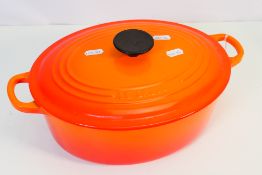 A Le Creuset oval casserole dish and cover, size 27, Volcanic.