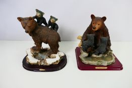 Two Juliana Collection figure groups, each depicting a mother bear and cubs,