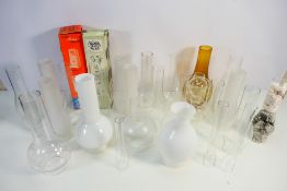 A collection of various oil lamp chimneys.