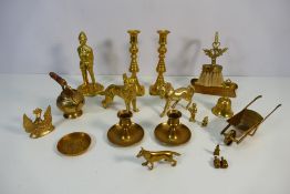 A collection of brassware to include animal figures, policeman figure, candlesticks and other.