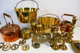 A collection of metalware, predominantly brass to include candlesticks, kettles and other.