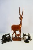 Lot to include a Singer Model 20 miniature sewing machine, one other similar and a wooden carving.