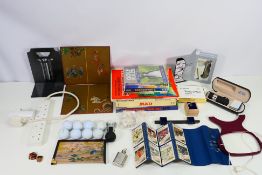 Lot to include golfing items, annuals, playing cards and other.