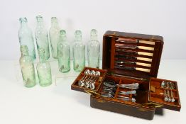 A part canteen of cutlery and a quantity of vintage glass bottles.