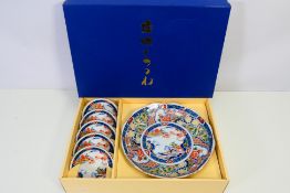 A set of boxed various sized Japanese plates,