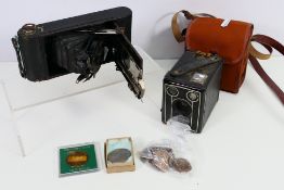 Two cameras and a small quantity of coins.