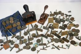 A vintage embossing press and large quan