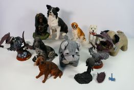 A collection of animal figures and similar to include dogs and eagles and two pug form door stops.