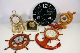 A collection of clocks and a barometer to include an anniversary clock, wall clocks and similar.