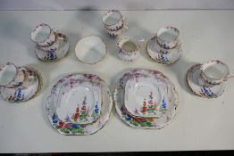 A collection of New Chelsea, Staffs tea wares decorated in the Lattice Hollyocks pattern,