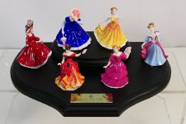 Six Royal Doulton miniature lady figures with wooden display stand, comprising Belle, Patricia,