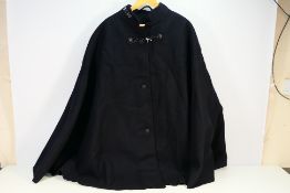 British police officer’s black cape, with lion’s head boss and chain fastener, collar numbered 2710,