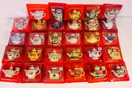 A quantity of miniature teapots from the Porcelain Art Miniature Teapot Collection,