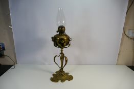 An Art Nouveau style brass oil lamp stand and font, approximately 69 cm (h) including chimney.