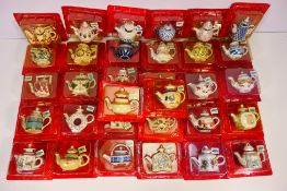 A quantity of miniature teapots from the Porcelain Art Miniature Teapot Collection,