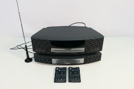 A Bose Wave Music System, model AWRCC5, with Multi-CD Changer accessory, remotes and cables.