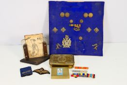 Lot to include a Princess Mary Gift Fund brass tin, cap badge, display of buttons and similar.