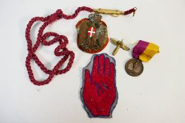 Lot to include an Italian African Police cap badge and cord,