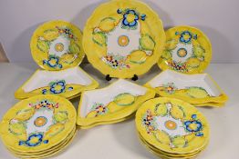 A collection of hand painted Italian table wares decorated with flowers and fruit, seventeen pieces.