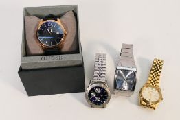 A boxed Guess wristwatch and four unboxed watches to include Sekonda and other.