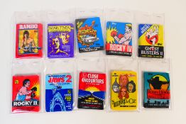A collection of unopened movie related trade card / bubble gum / sticker packs to include Jaws 2,