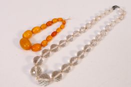 An amber bead bracelet, largest bead approximately 2.5 cm x 1.2 cm, smallest 1 cm x 0.6 cm, 13.