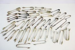 A collection of vintage sugar tongs.