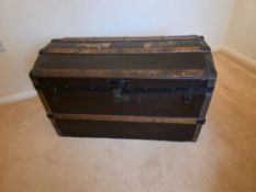 A metal bound dome top trunk measuring approximately 58 cm x 91 cm x 50 cm.