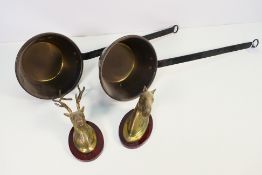 Lot to include a brass horse mask and stag mask mounted to wooden plinths and two pans.