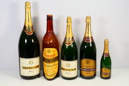 A collection of empty champagne and spirit bottles to include a Methuselah.