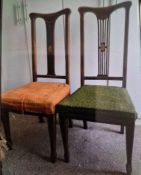 A pair of Art Nouveau style chairs with inlaid decoration and pierced back slats 42 inches tall.
