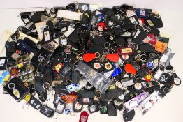 A very large quantity of keyrings, automotive related, advertising and other.