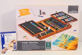 A boxed Crelando 174 Piece Artist's Paint Box and a box of permanent markers.