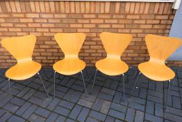 A set of four bent wood chairs with chrome effect supports. [4].